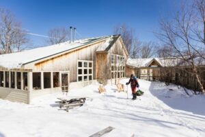 Skier leaving Stratton Brook Hut in winter